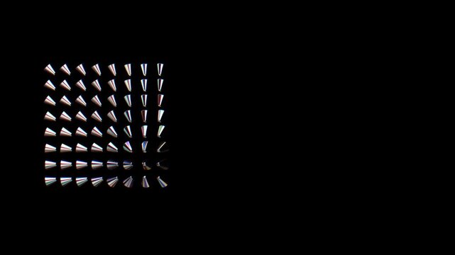 Top-down view of cone-shaped objects arranged in a neat geometric grid on a black background, each reflecting subtle rainbow hues under studio lighting