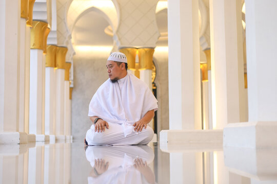 Front View Of Asian Muslim Man Performing Salam Or Taslim To Finish Prayer