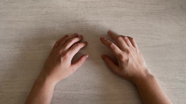 Two Hands Tapping Fingers on Table Impatience Body Language