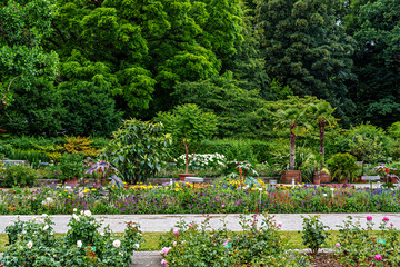 The Botanical Garden of Augsburg in Germany with garden pathes and topiary boxwood bushes on green meadows