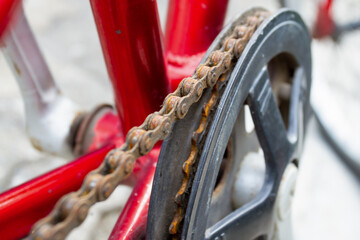 Extreme close-up macro shot of a severely rusty bicycle chain and chainring, highlighting neglected...