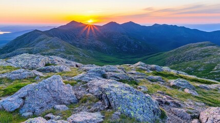 Fototapeta premium Mountain's Majesty: Witness the awe-inspiring beauty of a mountain range at sunrise, with jagged peaks and rolling hills kissed by the golden rays.