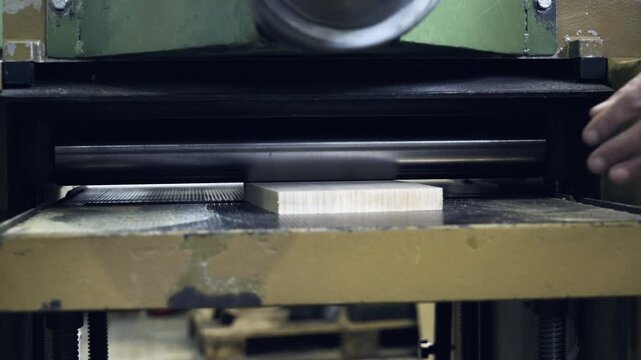 Professional wood thicknessing process in a carpentry workshop