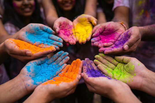 Hands Holding Colorful Powder During Holi Festival Celebration in India. Holi Color powder background
