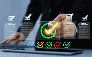 Business person checking digital documents on laptop with checklist approval icon, verification, workflow control, productivity and online document management.