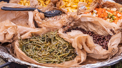 Assorted traditional vegetables and grains in paper