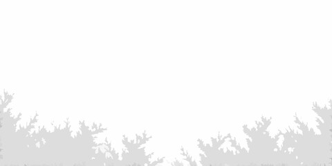 Naklejka premium Silhouetted trees against a bright almost entirely white background