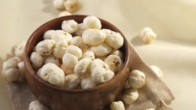 Makhana on wooden bowl closeup shot in panning motion.