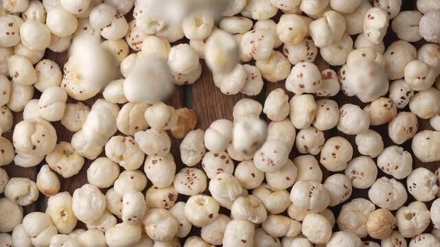 Makhana falling on tray closeup shot.