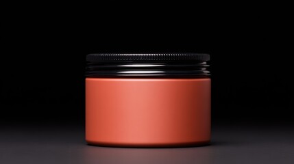 A sleek, modern jar with a matte orange finish and a black lid, set against a dark background, highlighting its elegant design.