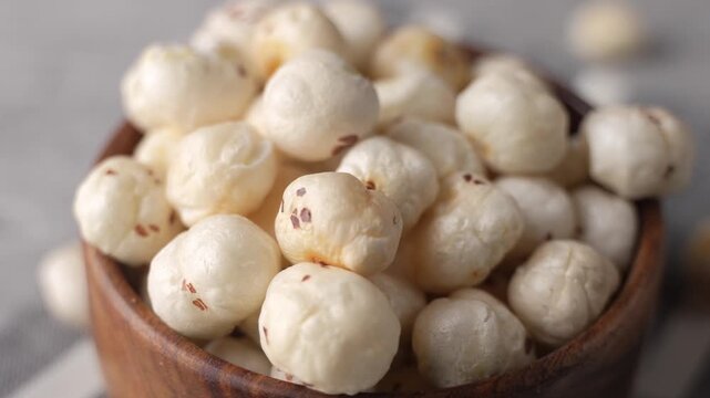 Makhana on wooden bowl closeup shot in panning motion.