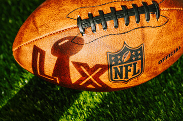 Obraz premium A shadow in the shape of ‘LX’ with the Lombardi Trophy cast on an American football ball ahead of Super Bowl LX between the Seattle Seahawks and New England Patriots at Levi’s Stadium in Santa Clara
