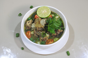 Traditional Indonesian Beef Rib Soup with Fresh Lime and Vegetables