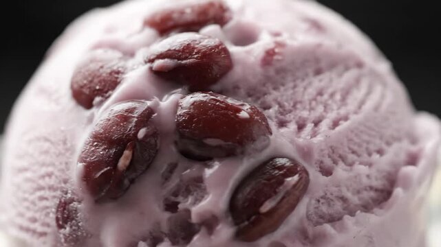 Extreme Close-Up of Azuki Red Bean Ice Cream Scoop Melting with Condensation Detail Against a Dark Background