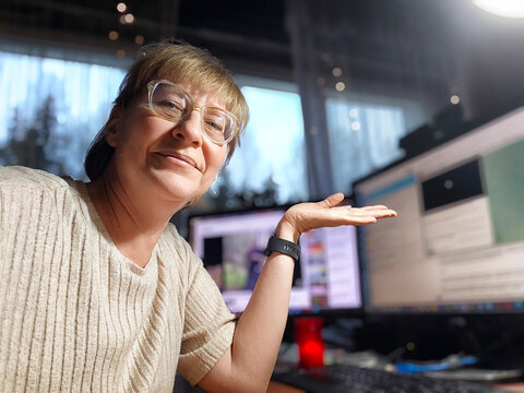 Woman enjoys her daily routine while working from home at a cozy desk setup with a computer screen