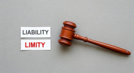 Judge gavel with liability and limited signs on gray background