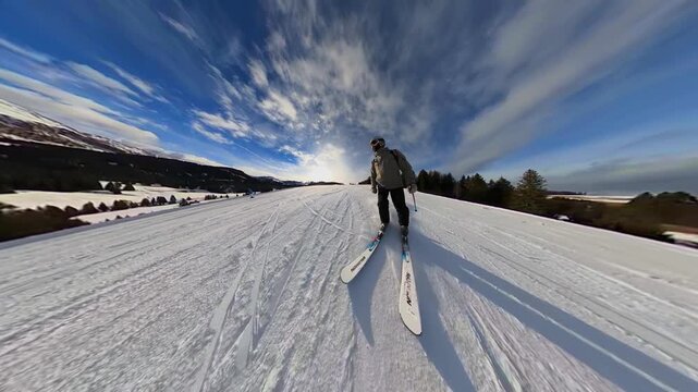 A wide-angle shot of skiers on a snow-covered slope at Alpe di Siusi in the Italian Dolomites. The vast, open landscape under a deep blue sky captures the solitude and grandeur of the Alpine mountains