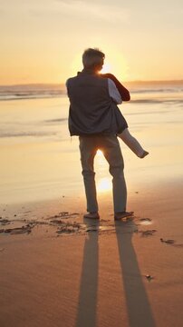 Elderly couple enjoying romantic sunset on beach