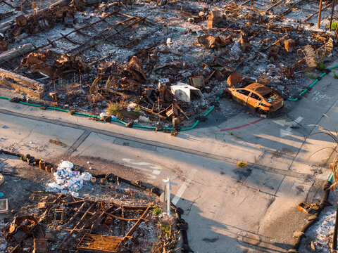 Aerial view of the aftermath of a fire leaving behind charred remains of homes and vehicles near the Pacific Palisades Bowl, Pacific Palisades, California, United States.