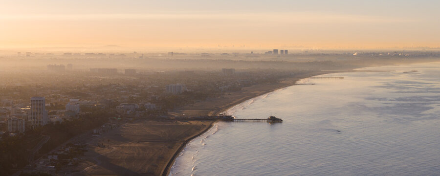 Aerial view of a golden dawn kissing the Santa Monica Pier as the Pacific Ocean whispers secrets to the shore, Via de la Paz, California, United States.