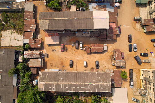 Aerial view of rooftops and parked vehicles, showcasing the urban layout and daily life of the city, Ado Ekiti, Ekiti, Nigeria.