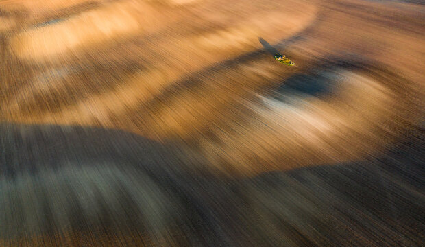 Aerial view of vast undulating fields in earthy colors, prepared for sowing, Svatoborice, Jihomoravsky kraj, Czechia.