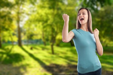 Beautiful middle-aged young woman walking in city park