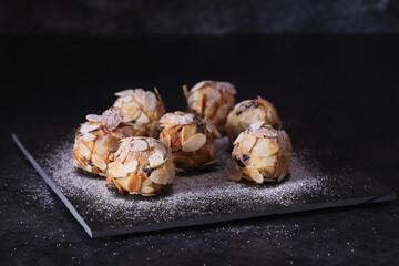 Italian amaretti cookies on a dark background. Italian cookies with almonds. The cookies are round.