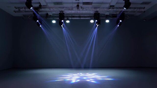 Dynamic stage lighting setup with blue and green beams illuminating an empty performance space. Ideal for concerts, events, and theatrical productions