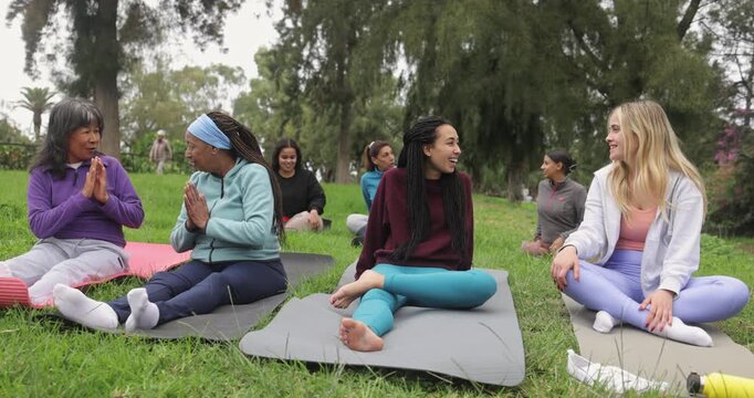 Multiracial women having fun together after yoga class outdoor - Healthy lifestyle, multi generational people and sport concept 
