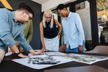 Team working on architectural project designs in modern office