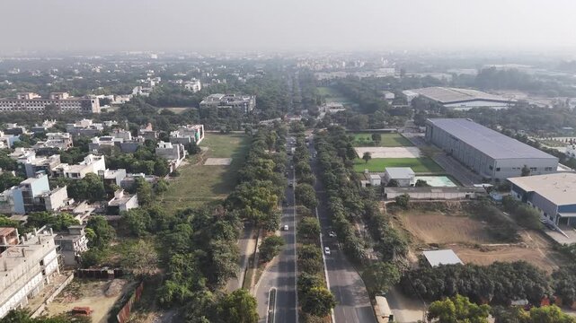 Drone shot of Alpha I, Sector 31, Greater Noida, featuring organized industrial complexes, green corridors, and broad internal roads reflecting the city&rsquo;s planned industrial landscape.