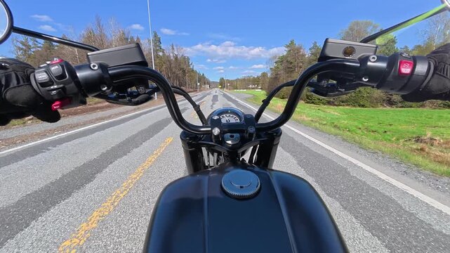 POV chest-mounted action camera footage of riding a cruiser motorcycle on a straight, smooth road in Norway during summer. Green trees and countryside scenery pass by, capturing a relaxed road trip, f