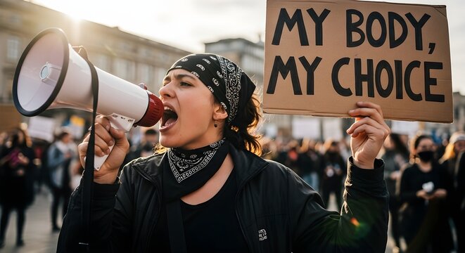Women's Rights Protest. Angry female activist shouting into megaphone while holding My Body My Choice sign during public demonstration for reproductive freedom and abortion rights