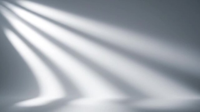 Abstract composition of bright light and shadows on a minimalist, gray gradient background