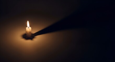 Single Lit Candle Illuminating a Dark Room with a Long Shadow.