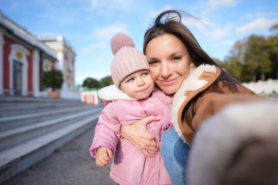Portrait of cute little girl and young mother hugging together. Family and love concept. Mother and daughter time.