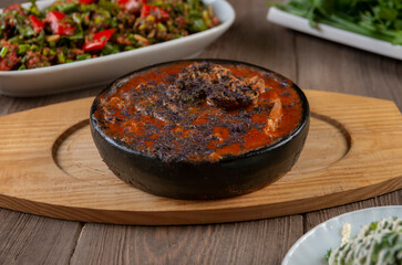 Traditional caucasian dishes on a wooden table .