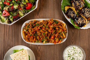 Traditional caucasian dishes on a wooden table .