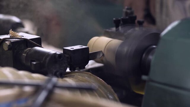 Close-up of a spinning wood lathe drilling and cutting a wooden piece
