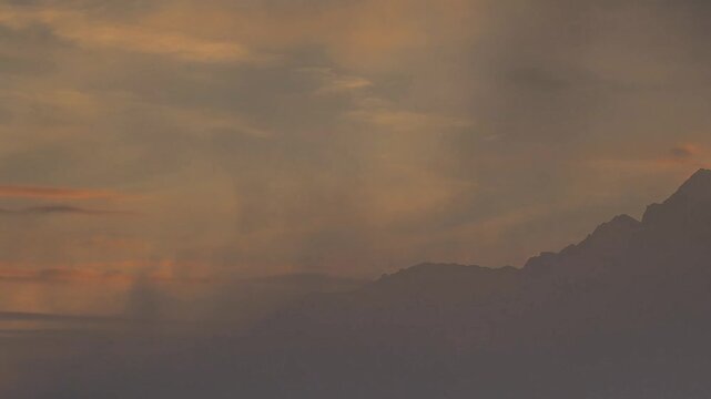 Moving clouds and fogs towards Emilius peak, Aosta valley