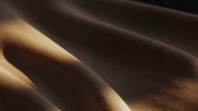 Soft beige and brown fabric texture with gentle folds and soft shadows, warm sepia tones and subtle wave like creases creating a calm, minimal background with copy space