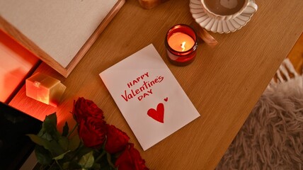 Naklejka premium Cozy Valentine's Day scene with roses, candle, and coffee on a wooden table
