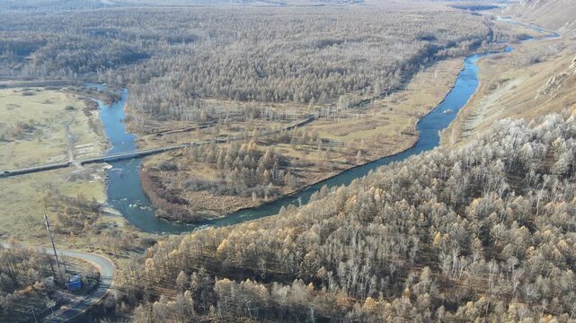 Drone Pull Back Over Winding Halaha River and Autumn Forest in Arxan, Inner Mongolia, China