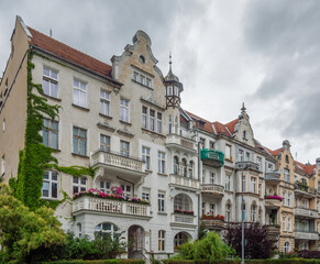 Fototapeta premium Elegant pre-war architecture of Wrocław, Poland, a city known for its diverse and beautifully preserved historic buildings. Grand, off-white facade featuring a mix of Art Nouveau and eclectic styles 