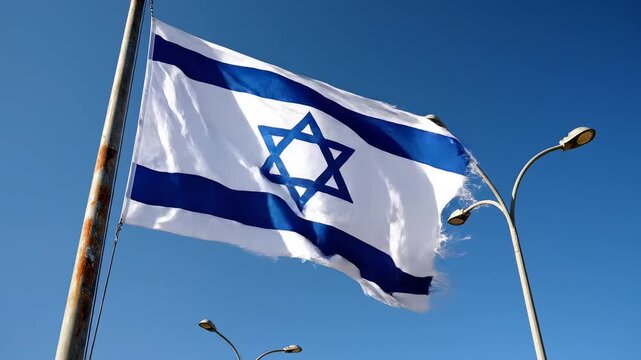 Israeli flag waving in blue sky