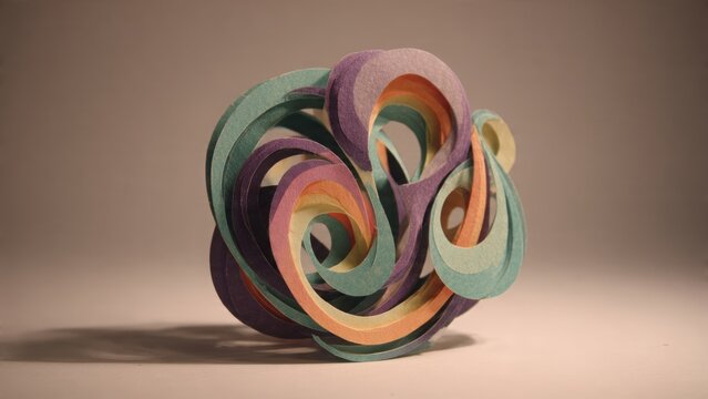 Intricate Sculpture: A captivating close-up showcases a modern artistic sculpture, its multi-layered design of interwoven forms, bathed in soft lighting.