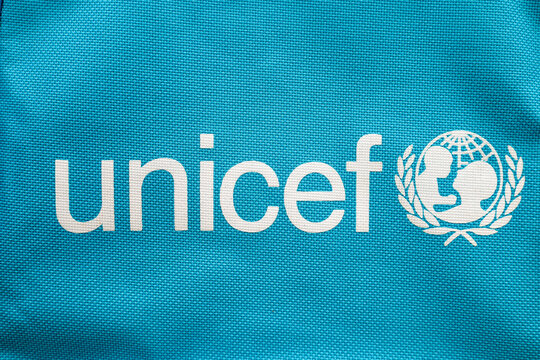Lviv, Ukraine - January 24, 2026: The UNICEF logo, featuring the organization's name in lowercase and an emblem depicting a globe with a mother and child silhouette enclosed in a laurel wreath.