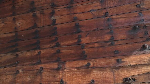 Construction of a wooden ship. Shipyard of traditional Dhow wooden boat on Iranian Qeshm Island. Board of Tradition Lenz Fishing Boat in Southern Iran. Old wooden stealth smuggler's ship.