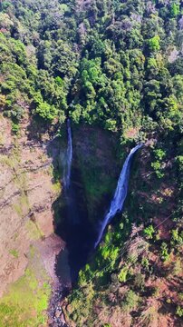 Top aerial side view of Tad Fane Waterfall and rainforest at Pakse, Laos